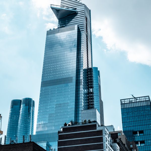 A vertical low angle shot of modern glass business buildings touching the sky